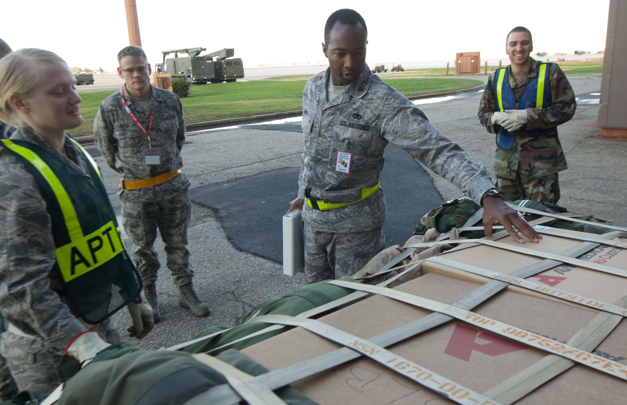 LANGLEY AIR FORCE BASE, Va. -- Maj. Anthony Mims, Wing Exercise Evaluation Team member, examines a pallet during a Phase I Operational Readiness Exercise Dec. 3. Wing Exercise Evaluation Team members will assess the ability of 1st Fighter Wing units to deploy cargo, aircraft and Airmen within a limited timeframe. (U.S.  Air Force photo/Staff Sgt. Barry Loo)