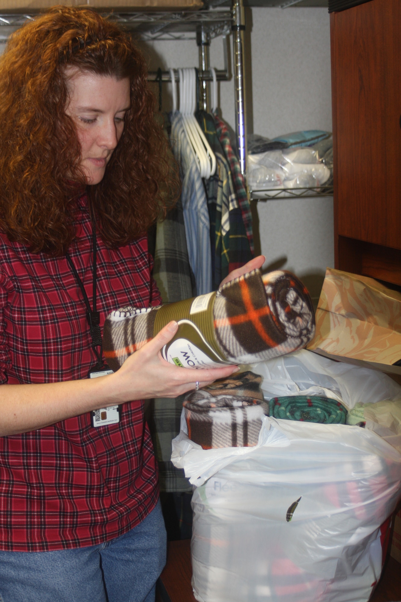 WRIGHT-PATTERSON AIR FORCE BASE, Ohio – Master Sgt. Alicia Lavender, 445th Maintenance Group, drops off blankets she donated that will be brought out on Dec. 5 to the residents of the Veterans Affairs Medical Center, Dayton, Ohio. Volunteers from the 445th Maintenance Group spent the afternoon filling more than 100 bags with items, such as soap, shampoo, lip balm and combs. Bags were built for both men and women so gender specific items could be included.  (U. S. Air Force photo/Stacy Vaughn)