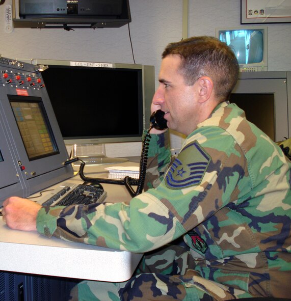 WRIGHT-PATTERSON AIR FORCE BASE, Ohio – Master Sgt. David Filipkowski, 445th Airlift Wing Command Post controller, disseminates information to and from the commander both up and down the chain of command. One of the many tasks of the command post controllers is that they are the point of contact from higher headquarters, a funnel for time sensitive information that flows between the commander and his boss. (U.S. Air Force photo/Senior Airman Mikhail Berlin)