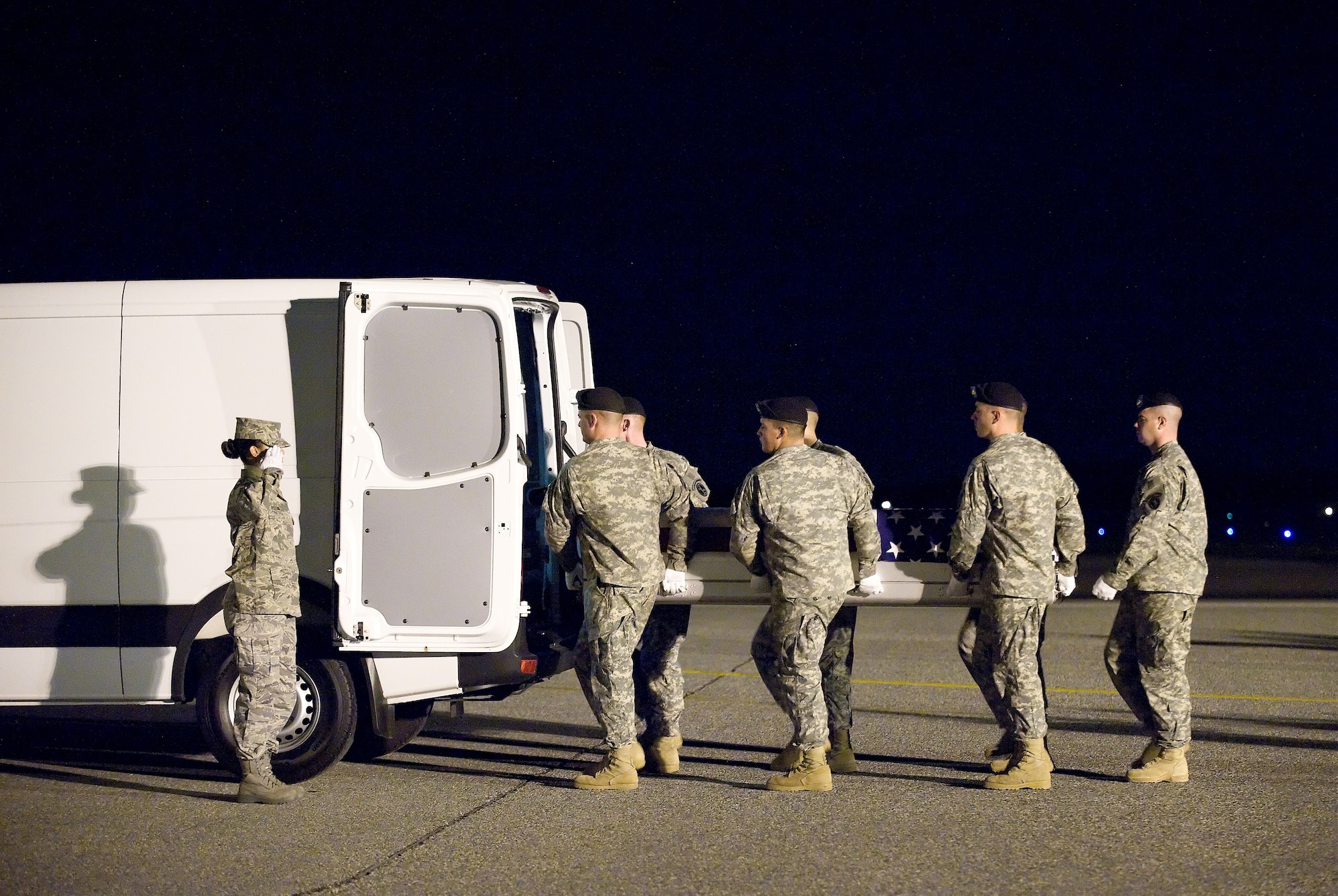 3 December 2009  USAF Photo by Jason Minto.  A U.S. Army carry team transfers the remains of Army CPL Kenneth R. Nichols Jr., of Chrisman, IL., at Dover Air Force Base, Del., Dec 3, 2009.  