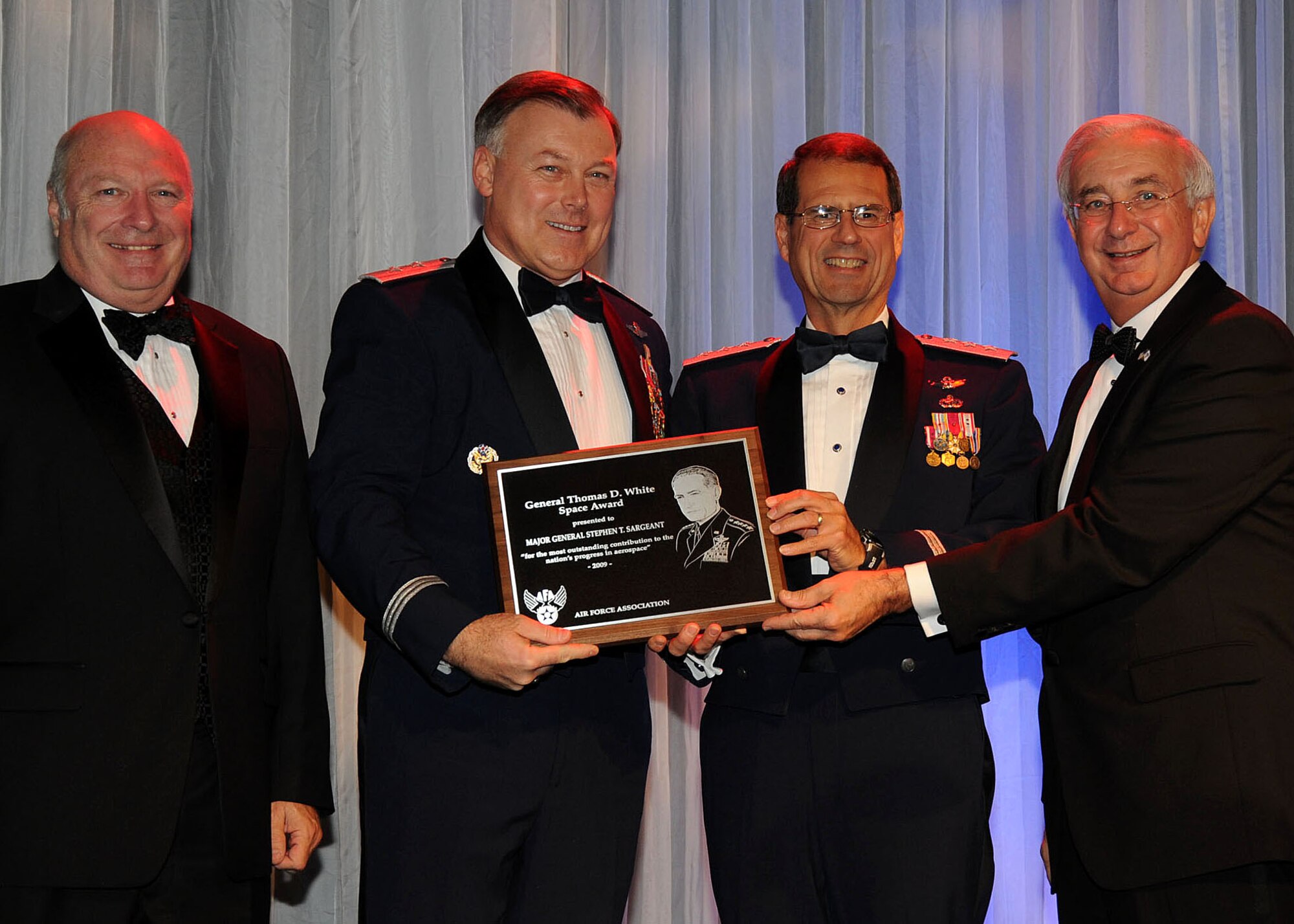 Maj. Gen. Stephen Sergeant (second from left), Air Force Operational Test and Evaluation Center commander, Kirkland Air Force Base, NM, receives the General Thomas D. White Space Award during the 38th annual Air Force Association Ball held in Beverly Hills, Nov. 20. The award was presented by (left to right) retired Air Force Maj. Gen. Thomas Taverney, AFA Schriever Chapter chairman of the board;  Lt. Gen. Tom Sheridan, Space and Missile Systems Center commander; and Mr. Joe Sutter, AFA National chairman of the board. (Photo by Lou Hernandez)