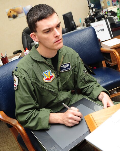 Capt. Timothy "Beetle" Tryon sketches the newest panel in his Air Force comic "Crew Dogs." Captain Tryon has been drawing comics since his freshman year of college. In 2006, he started creating Air Force-related comics based on his experiences. (U.S. Air Force photo by Senior Airman Megan M. Tracy)