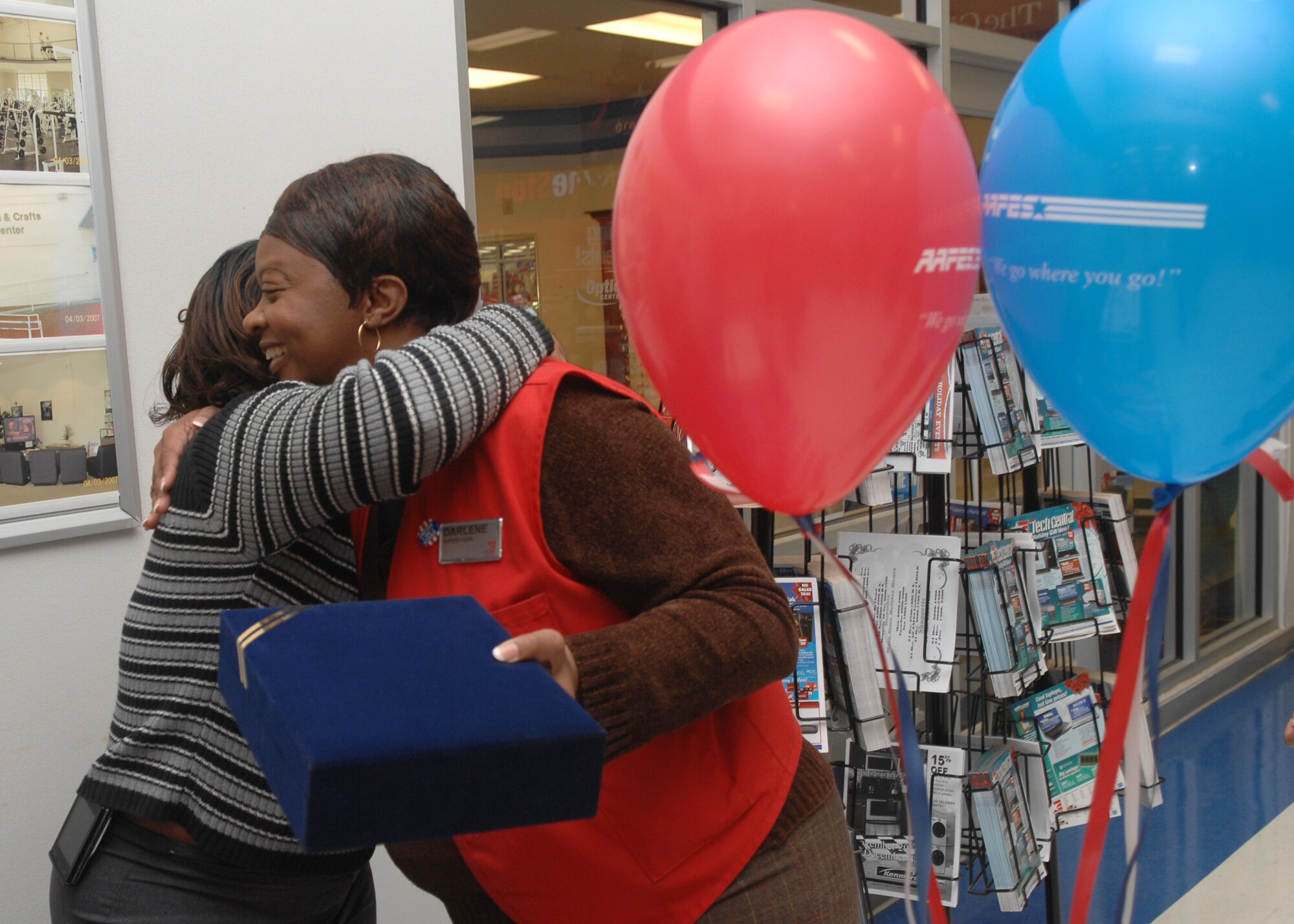 Darlene Downing is congratulated by a fellow AAFES employee after her welcome home ceremony at the Barksdale base exchange Dec. 1.  Ms. Downing, who comes from a military family, recently returned from a 14-month deployment in Afghanistan.  (U.S. Air Force photo by Staff Sgt. Sarah E. Stegman)