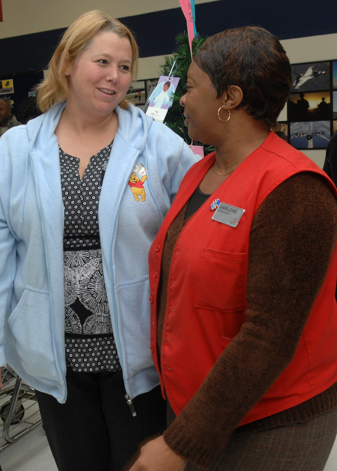 Lisa Dowden, AAFES Human Resources, talks with Darlene Downing after her welcome home ceremony at the base exchange Dec. 1.  Ms. Downing recently returned from a 14-month deployed in Afghanistan.  (U.S. Air Force photo by Staff Sgt. Sarah E. Stegman)