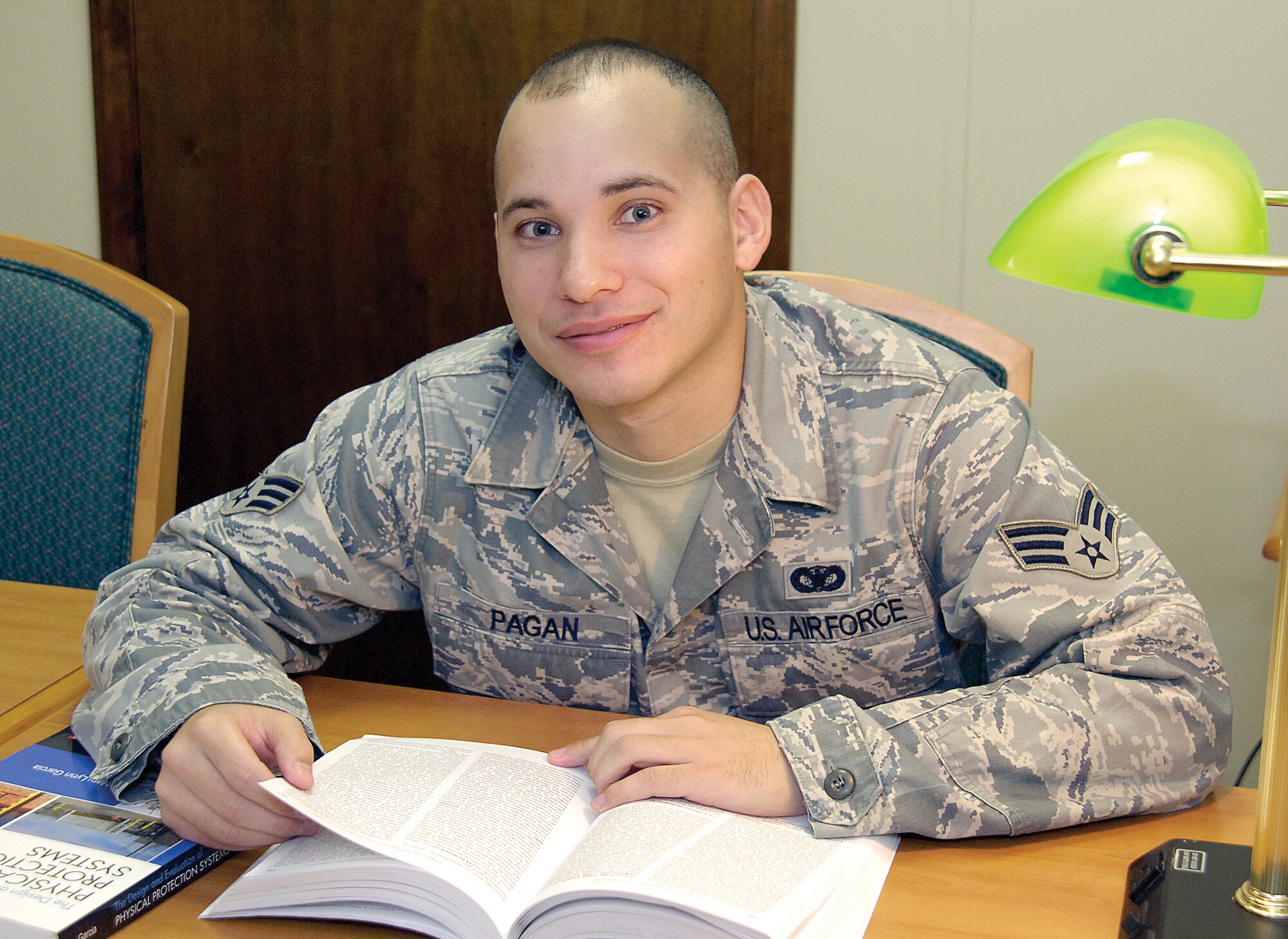 Senior Airman Luke Pagan, 72nd Security Forces Squadron, is a pro at finding quiet places, like the base library, to put in some study time as he pursues his doctorate degree. (Air Force photo by Margo Wright )