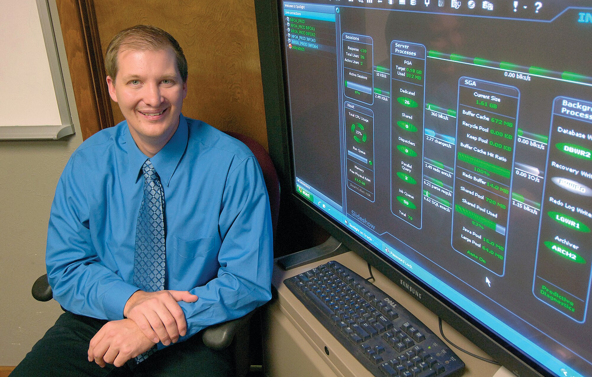 Air Force photo by Margo Wright Shenandoah Speers isn’t satisfied to just do his job. The 72nd Air Base Wing Communications Directorate database lead admits he always wonders if there is a way to do things smarter, better, when handling the challenges of managing hundreds of application- and web-based servers that mainly support the 76th Maintenance Wing. Air Force Materiel Command directed him and his team to consolidate servers and that was a challenge he loved to tackle. But his team wasn’t satisfied to just meet the minimum requirements. They saw and resolved customers’ problem, often resolving issues before the customer was aware there was a looming problem, or, after many methods had already been tried by others yet failed. “There is no limit to his abilities or his willingness to help people,” said Kelley Butler, Communications Directorate deputy director. “He regularly solves tough technical issues and not only makes it look easy but is also one of the most pleasant people you have ever met.”  Server consolidation methods, including creating virtual servers, took the AFMC goal further, saving more taxpayer money, increased cyber security and upped energy efficiency.  “I love the challenge,” Mr. Speers said. “When someone says ‘that can’t be done’ …. Oh yeah, it can be,” he said enthusiastically.  The live-time active screen that fills a corner of Mr. Speers’ office helps him monitor the performance of production databases.
