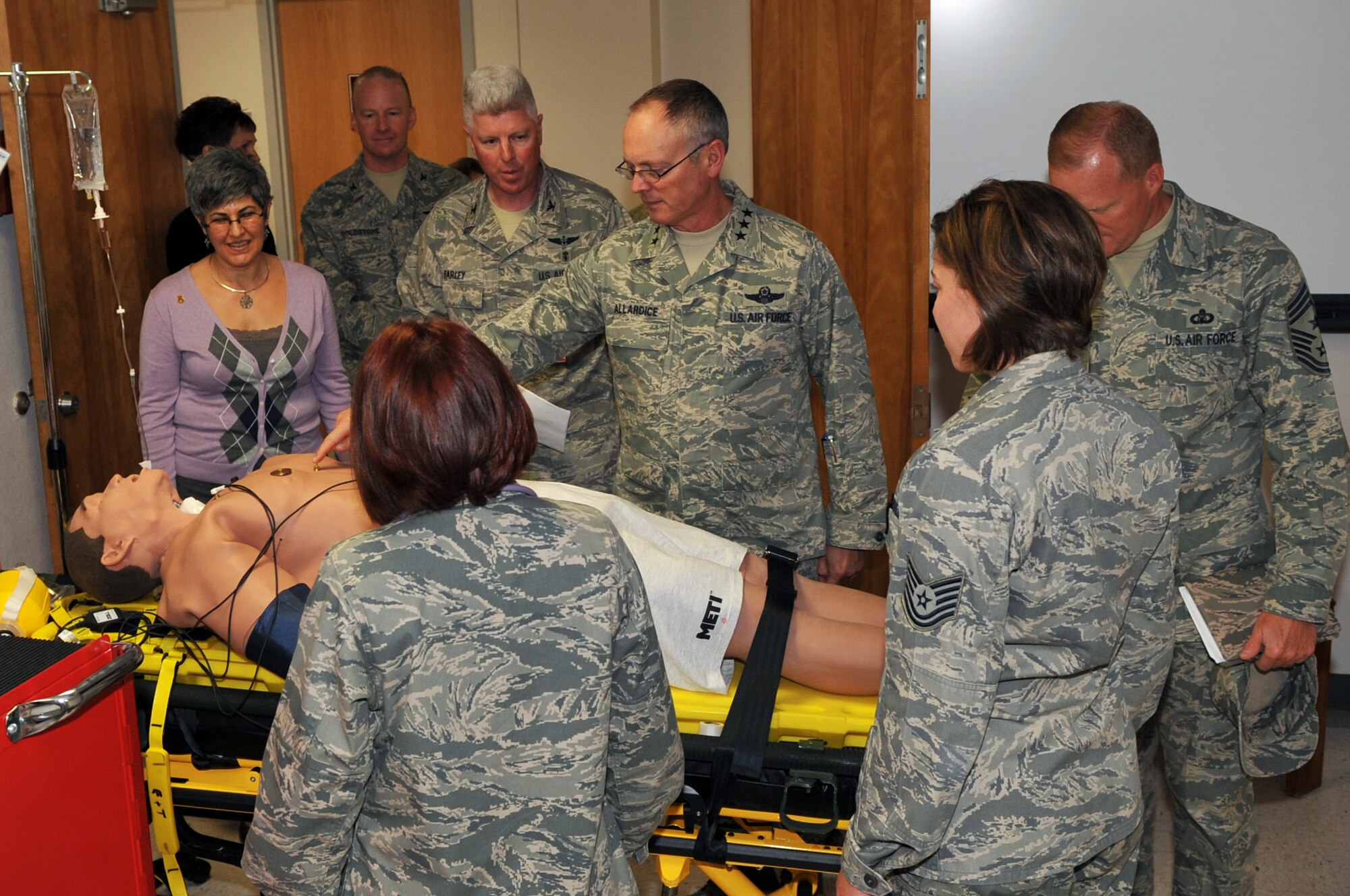 SCOTT AIR FORCE BASE, Ill -- Lt. Gen. Robert R. Allardice, 18th Air Force commander looks on as TSgt. Jamie Barrick, 375th Medical Support Squadron education and training (left) and Capt. Liam Aponte 375th Aeromedical  Staging Flight commander explain the purpose of the I.Stand, a simulation mannequin used for medical training Nov. 24. Gen. Allardice visited various section of the medical group during his two-day visit to Scott AFB. (U.S. Air Force photo by Senior Airman Teresa M. Jennings)