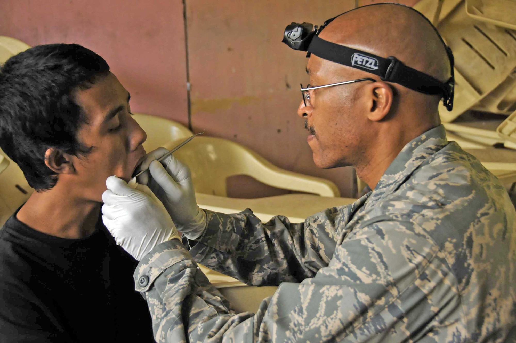Lt. Col. Arnold Stocker examines the mouth of a young boy during a Medical Civic Action Project Nov. 28, 2009, in Jolo, Philippines. Colonel Stocker is a nurse anesthetist assigned to Joint Special Operations Task Force-Philippines. (U.S. Navy photo/Lt. j.g. Theresa Donnelly)