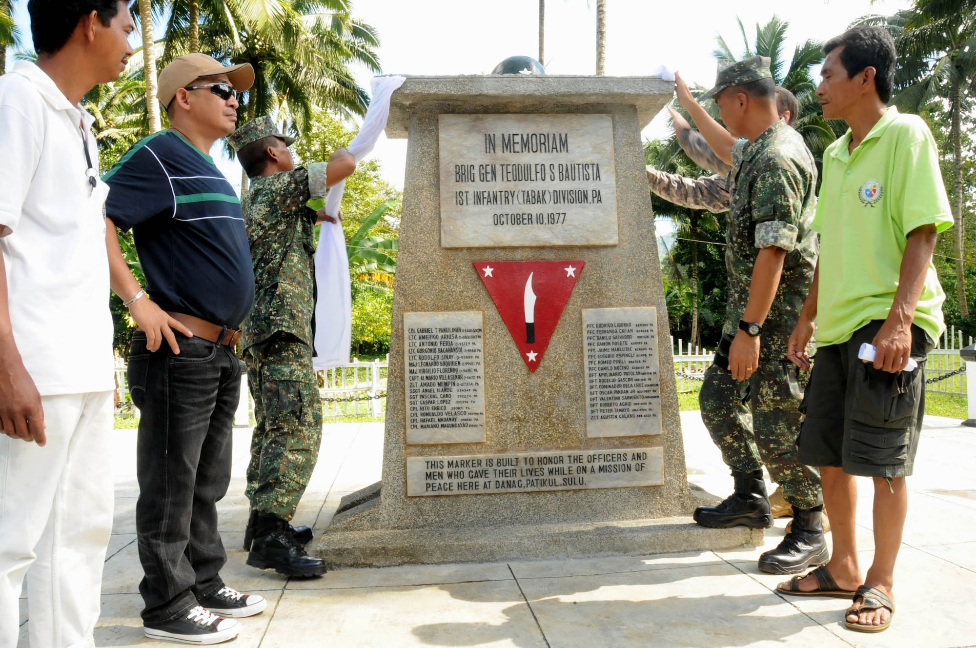Sulu community leaders, members of the armed forces of the Philippines and Joint Special Operations Task Force-Philippines American servicemembers unveil a shrine Nov. 28, 2009, in Patikul, Philippines. The stone shrine is a tribute to AFP Brig. Gen. Teodulfo Bautista and his 34 men who were killed Oct. 10, 1977, while attempting to conduct peace talks. (U.S. Navy photo/Lt.j.g. Theresa Donnelly)