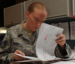 LANGLEY AIR FORCE BASE, Va. --  Staff Sgt. Lisa Reesey, 1st Comptroller Squadron unit deployment manager, looks over a mobility folder during the Operation Readiness Exercise Dec. 4.  Wing Exercise Evaluation Team members assessed the ability of 1st Fighter Wing units to deploy cargo, aircraft and Airmen within a limited timeframe.  (U.S. Air Force photo/Senior Airman Zachary Wolf)