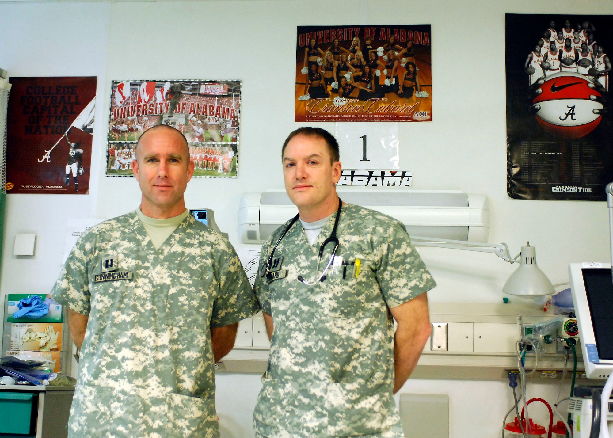 Capts. Frank Cunningham and Matt Howard stand next to Trauma Bay No. 1, named in honor of the University of Alabama Dec. 12, 2009 at the Craig Joint Theater Hospital at Bagram Airfield, Afghanistan. Many NCAA teams, especially those from the Southeastern Conference sent memorabilia to the Craig Joint Theater Hospital to brighten the spirits of the wounded servicemembers and staff. (U.S. Air Force photo/Senior Airman Felicia Juenke)