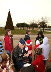 Col. William H. Mott V, 37th Training Wing commander, and a group of Team Lackland children begin the countdown to the base Christmas tree lighting at the Gateway Club Dec. 1. The annual Christmas tree lighting ceremony featured a reception in the club ballroom as well as a visit from Mr. and Mrs. Santa Claus. (U.S. Air Force photo/Robbin Cresswell) 