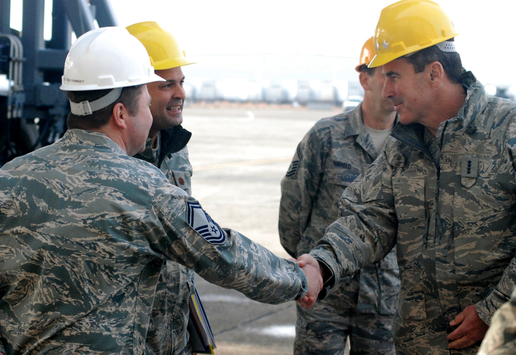 Gen. Raymond E. Johns Jr., commander of Air Mobility Command, shakes hands with
Senior Master Sgt. Todd Ramsey, 439th Maintenance Squadron, left, and Maj. Luis Nunez, 439th MXS commander,
during the general's tour of the isochronal inspection area at Westover Dec. 2. General Johns visited Westover to
meet with AMC Airmen and learn more about the command's current mission directly from them. This is the
general's first trip as commander of AMC. General Johns has made these trip his first priority to "get out and see
the mission through the eyes of AMC's amazing Airmen." The general's first stateside trip includes visits to Guard,
Reserve and active duty bases in Ohio, New York, Massachusetts, New Hampshire and New Jersey.