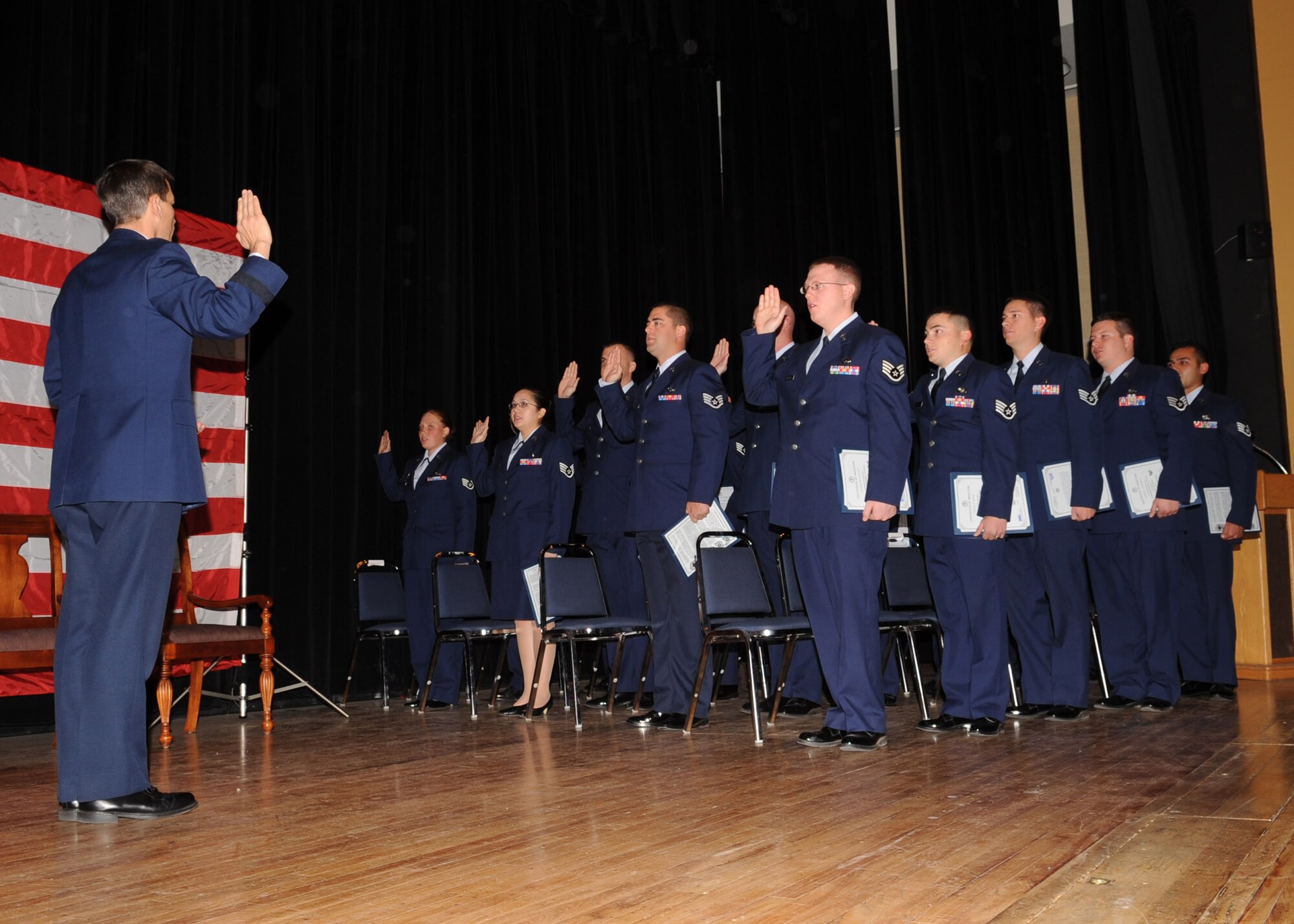 Brig. Gen. Paul Johnson, 355th Fighter Wing commander, administers the oath of enlistment to Davis-Monthan's newest staff sergeants during an NCO Induction Ceremony at the base theater Dec. 1. This ceremony, held monthly, recognizes the base's newest non-commissioned officers. (U.S. Air Force photo/Airman Jerilyn Quintanilla)
