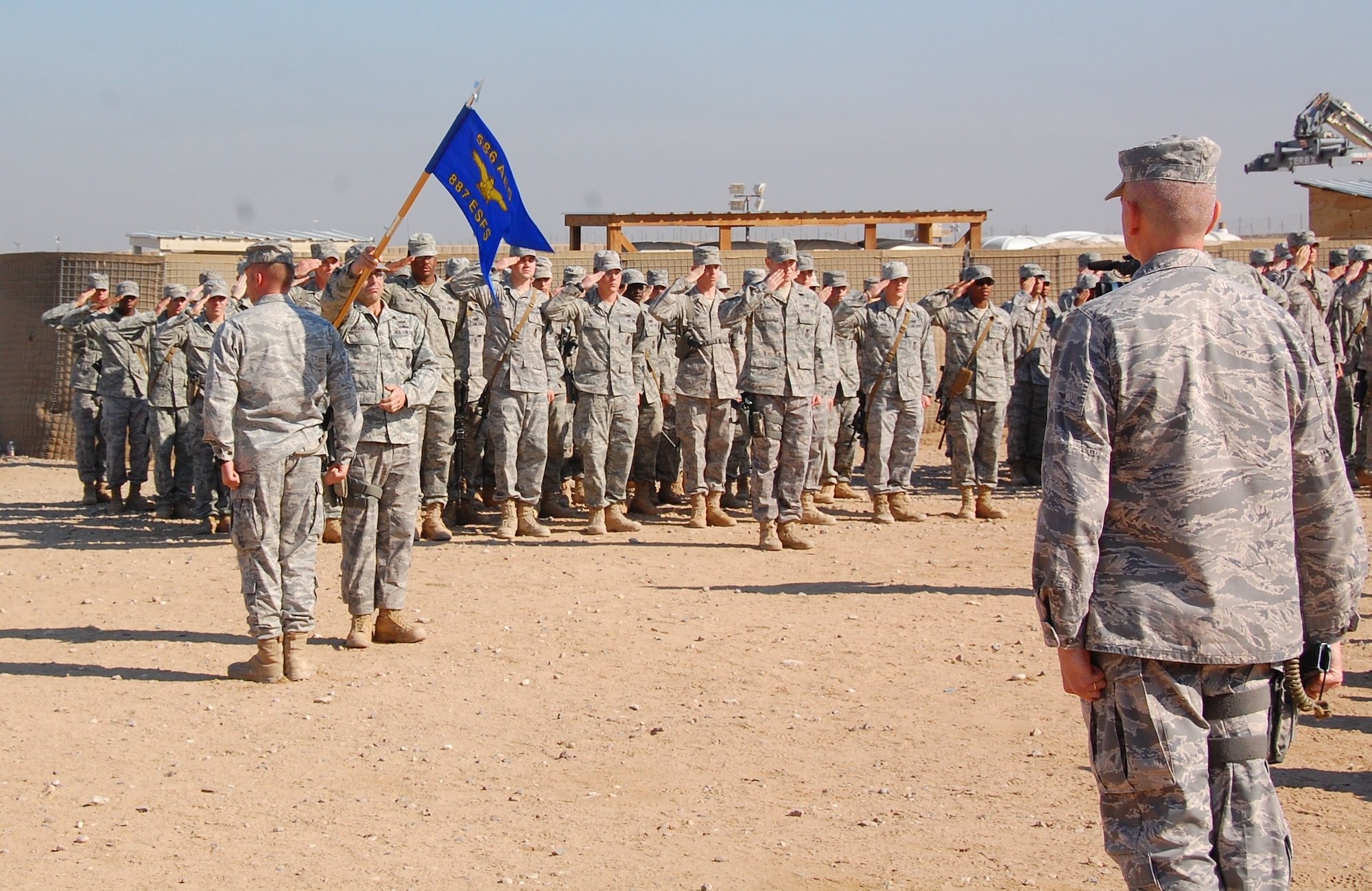 CAMP BUCCA, Iraq -- Members of the 887th Expeditionary Security Forces Squadron render their final salute to Maj. Larry Wood, 887th ESFS commander during the 887th ESFS Deactivation Ceremony Dec. 3. (U.S. Air Force photo/Staff Sgt. Shaun Emery)