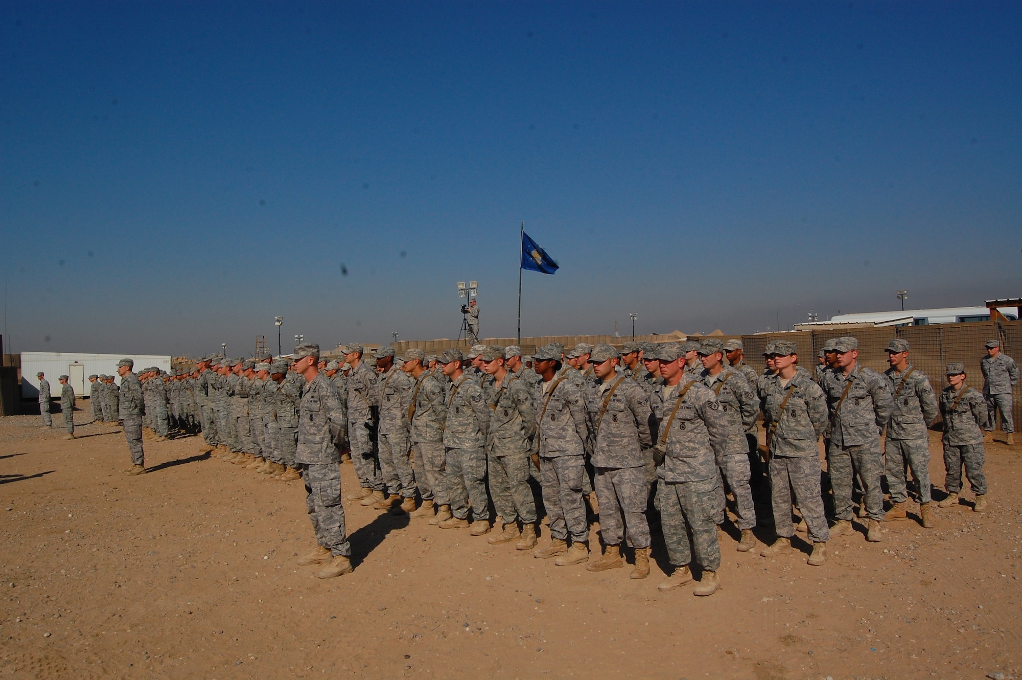 CAMP BUCCA, Iraq -- Members of the 887th Expeditionary Security Force Squadron stand in formation during the squadron’s deactivation ceremony Dec. 3. During their time there, members of the 887th ESFS conducted more than 6,500 outside-the-wire patrols in addition to 1,700 Air Force ISR missions. (U.S. Air Force photo/Staff Sgt. Shaun Emery)