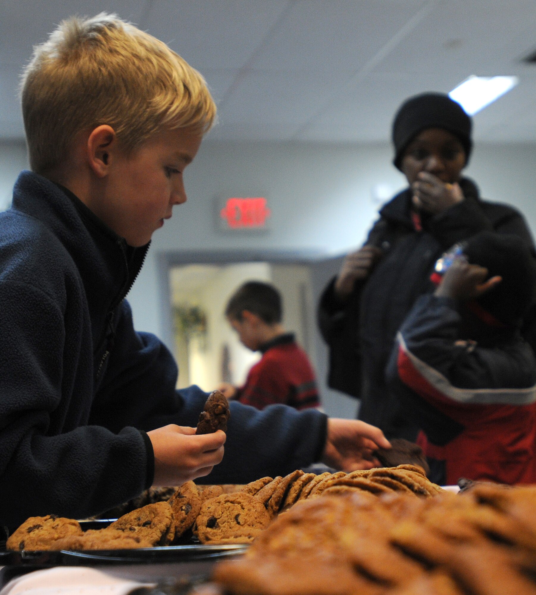 Chase Turner, son of Stacey and Lt. Col. James Turner, 39th Force Support Squadron commander, grabs cookies during Incirlik’s tree lighting ceremony Thursday, Dec. 3, 2009 at the base chapel.  The tree lighting ceremony is held every year during the holiday season to bring Airmen and their families together by lighting the base Christmas tree, serving cookies and hot chocolate, and a special visit from Santa.  (U.S Air Force Photo/Senior Airman Ashley Wood)