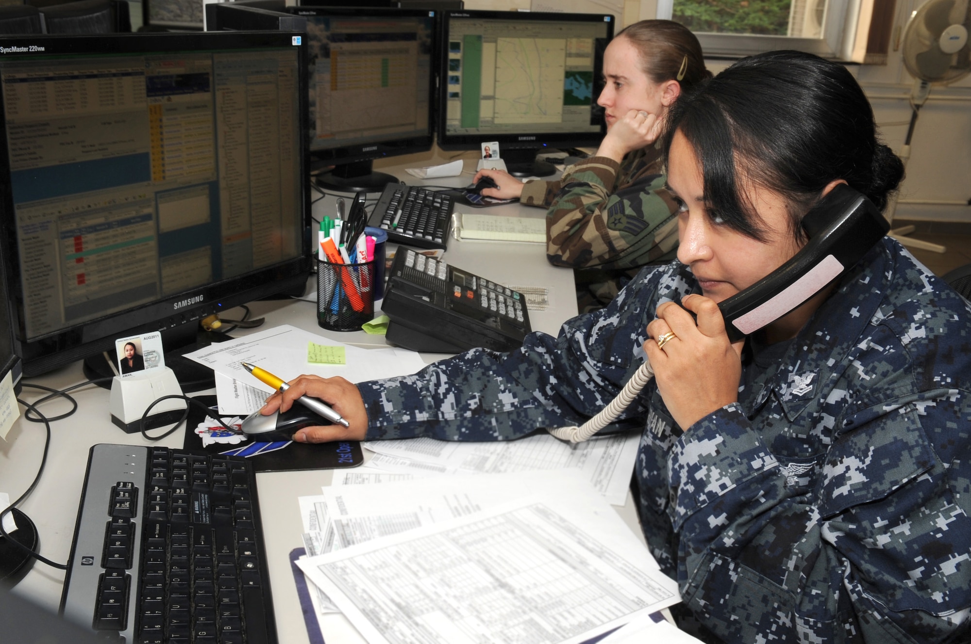 U.S. Navy Aerographers Mate, Petty Officer 2nd Class Susana Awan, relays updated weather conditions to pilots in flight at Dec. 3, 2009, Sembach Annex Germany. Awan works alongside U.S. Air Force personnel at the 21st Weather Squadron and they are responsible for weather support for Europe and Africa. (U.S. Air Force Photo by Staff Sgt. Jocelyn Rich)