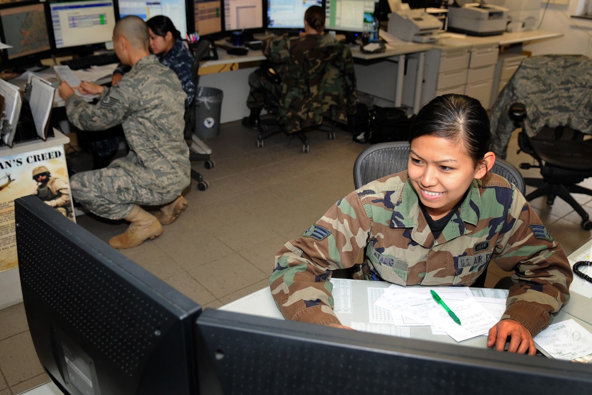 U.S. Air Force Senior Airman Maria Atalig, collects information on changing conditions to relay to pilots in flight on Dec. 9, 2009.  Atalig is a flight weather briefer with the 21st Weather Squadron at Sembach Annex, Germany. (U.S. Air Force photo by: Staff Sgt. Jocelyn Rich) 