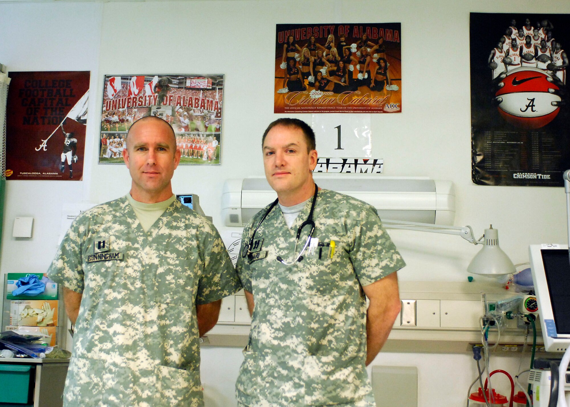 BAGRAM AIRFIELD, Afghanistan - Capts. Frank Cunningham and Matt Howard stand next to Trauma Bay #1, named in honor of the Alabama Crimson Tide.  Many NCAA teams, especially those from the South Eastern Conference sent memorabilia to the Craig Joint Theater Hospital here to brighten the spirits of the wounded servicemembers and staff.  (U.S. Air Force photo/Senior Airman Felicia Juenke)
