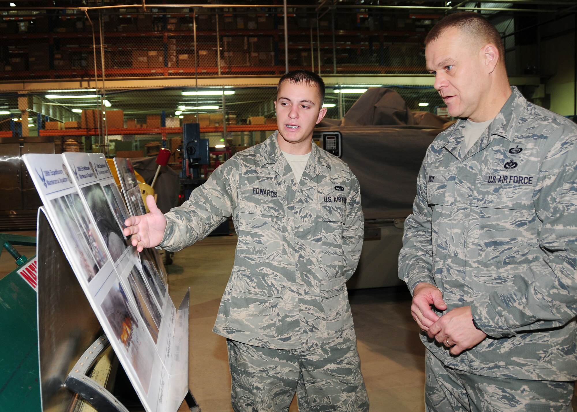 SOUTHWEST ASIA -- Senior Airman Steven Edwards, 386th Expeditionary Maintenance Squadron metals technician, briefs Chief Master Sgt. of the Air Force James Roy about the combat metals shop during his visit to the 386th Air Expeditionary Wing Dec. 2, 2009.  Airman Edwards is deployed from the 509th Maintenance Squadron, Whiteman Air Force Base, Mo., and hails from Charleston, S.C.  (U.S. Air Force photo/Tech. Sgt. Tony Tolley)