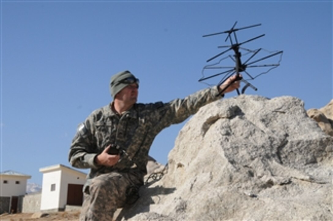 U.S. Army Cpl. Jason Ulin, with Provincial Reconstruction Team Ghazni, sets up a tactical satellite unit to communicate back to Forward Operating Base Ghazni after arriving at the Jaghori District Center in Ghazni province, Afghanistan, on Nov. 28, 2009.  The Provincial Reconstruction Team visited Jaghori to perform quality control and quality assurance on several projects funded by the team.  