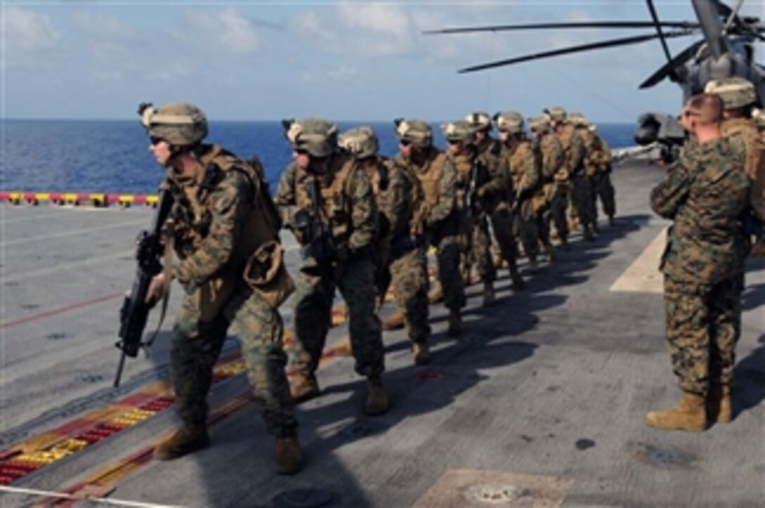 U.S. Marines with Fox Company, 2nd Battalion, 9th Marine Regiment, deployed aboard the multipurpose amphibious assault ship USS Wasp (LHD 1), perform combat marksmanship shooting exercises on the flight deck while the ship is underway in the Caribbean Sea on Dec. 1, 2009.  The Wasp is deployed on Amphibious–Southern Partnership Station 2009 with Destroyer Squadron 40 and embarked Security Cooperation Marine Air-Ground Task Force.  Southern Partnership Station is part of the Partnership of the Americas Maritime Strategy that focuses on building interoperability and cooperation in the region to meet common challenges.  