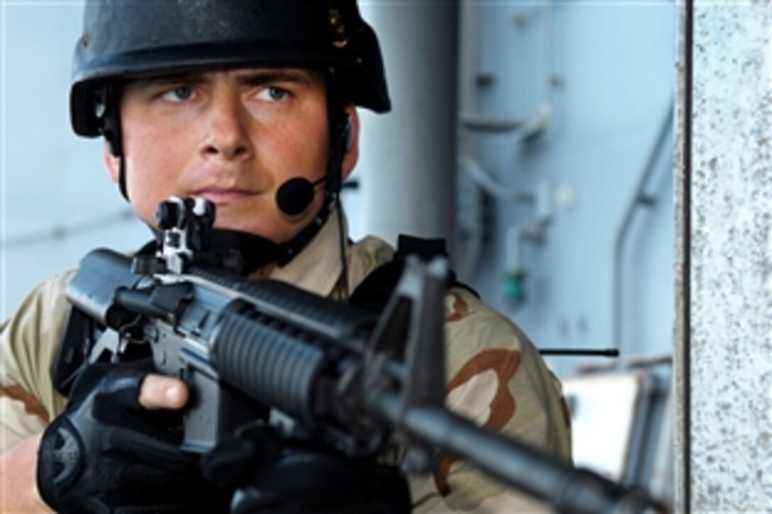 U.S. Navy Petty Officer 2nd Class Roger Byassee provides security during training with the visit, board, search and seizure team assigned to the guided-missile cruiser USS Chosin in the Gulf of Aden, Nov. 29, 2009. The Chosin is the flagship of Combined Joint Task Force 151, a multinational task force established to conduct counter-piracy operations under a mission-based mandate to actively deter, disrupt, and suppress piracy off the coast of Somalia.