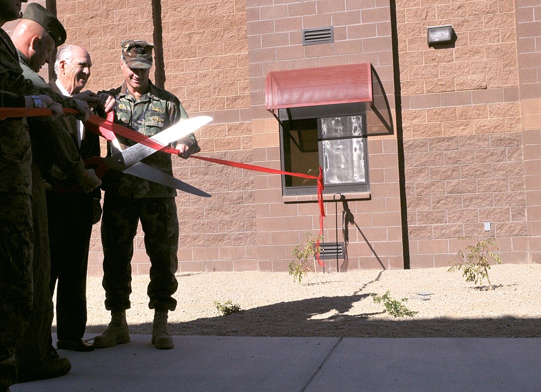 Col. Mark Werth, left, station commanding officer, and Ron Harper, founder of Harper Construction Company, cut the ribbon at the new Marine Air Control Squadron 1 barracks, which Harper Construction built, during the barracks’ ribbon cutting ceremony at the Marine Corps Air Station in Yuma, Ariz., Dec. 4, 2009. The nearly $22 million building will house approximately 200 Marines from MACS-1, Combat Logistics Company 16 and Marine Aviation Weapons and Tactics Squadron 1. The building is currently in the process of being Leadership in Energy and Environmental Design Silver certified, which verifies the building’s environmentally friendly construction and energy- and water-efficient design.