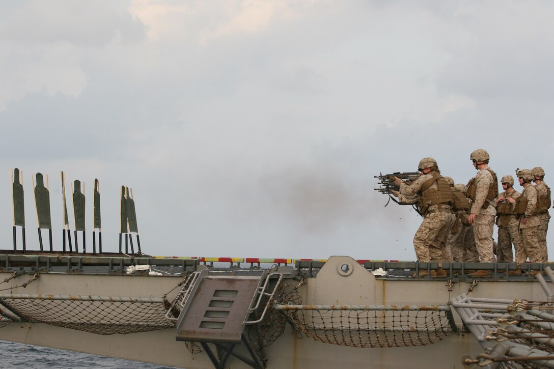 Squad automatic weapon gunners from Company E, Battalion Landing Team 2/4, 11th Marine Expeditionary Unit, fire their weapons in a sustainment training exercise aboard USS Bonhomme Richard Dec 4.