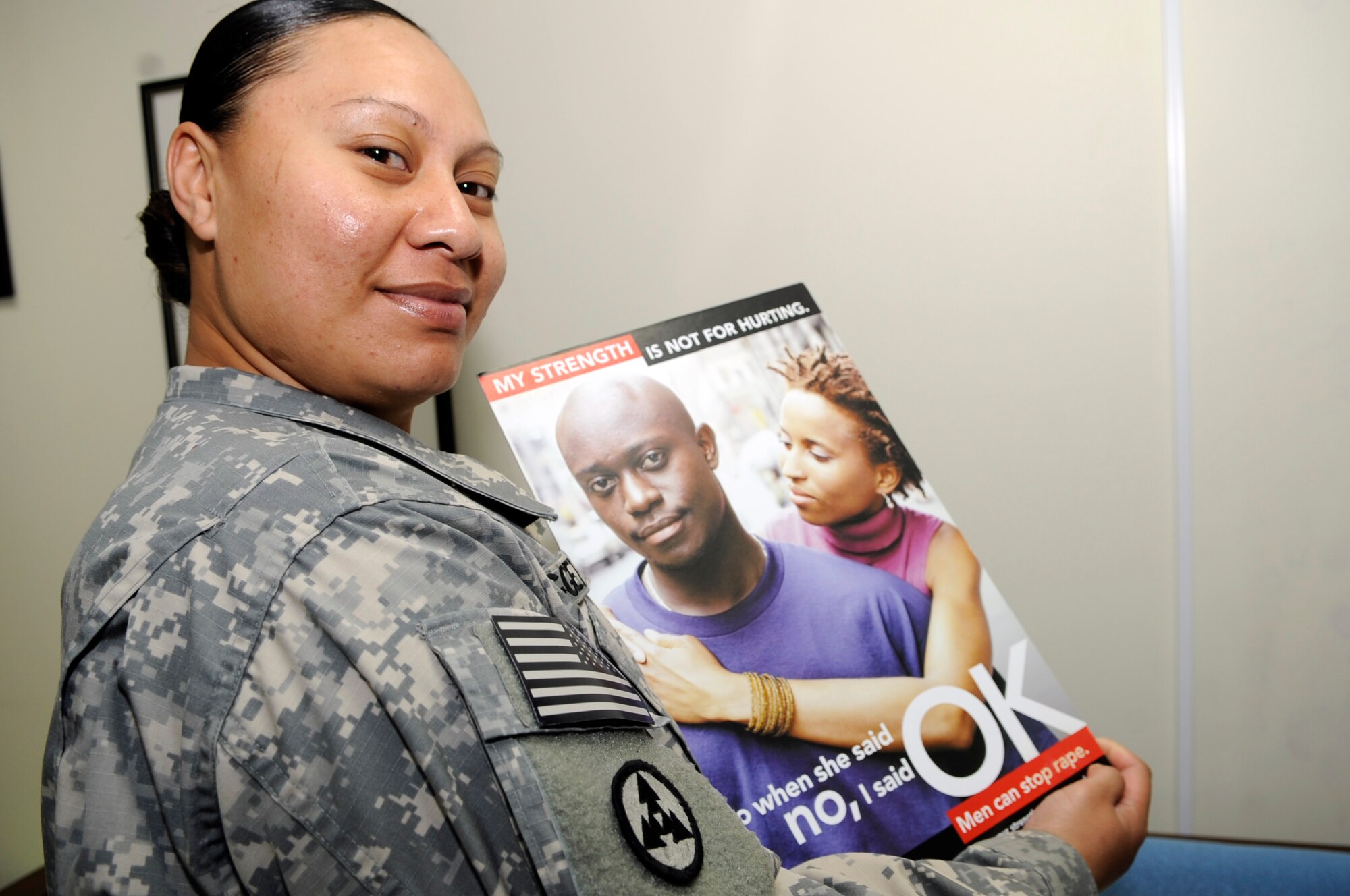 SOUTHWEST ASIA – Sgt. Ellen Leggett, U.S. Army, holds up a “Men Can Stop Rape” poster after finishing 40 hours of training to become a victim advocate Dec. 4, 2009. The 380th Air Expeditionary Wing Sexual Assault Prevention and Response Office trained 11 Airmen and Soldiers as victim advocates in a course from Nov. 29 – Dec. 4, 2009. Sergeant Leggett is deployed from Fort Bragg, N.C., and hails from Pago Pago, Samoa. (U.S. Air Force photo/Senior Airman Stephen Linch)