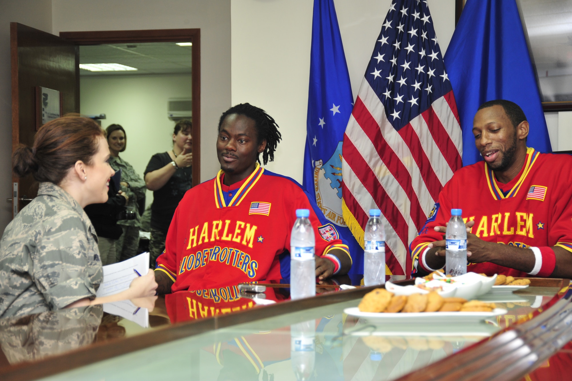 SOUTHWEST ASIA--In a visit to the 380th Air Expeditionary Wing Dec. 4 and Dec. 5., 2009, the Harlem Globetrotters sat down with 2nd Lt. Kidron B. Vestal, 380th Air Expeditionary Wing chief of public affairs. Willie Shaw and Anthony Greenup, the scorer of the game-winning point, said their motivation to support various causes springs from a calling to be "ambassadors of goodwill." The team performed for several hundred deployed Airmen and Soldiers. (U.S. Air Force Photo/TSgt Charles Larkin Sr)