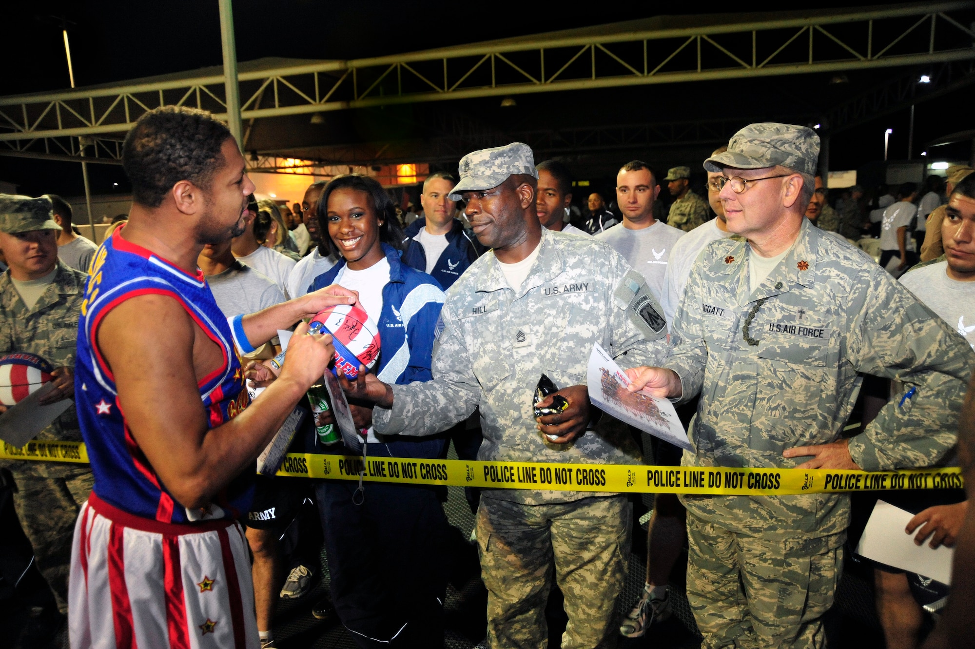 SOUTHWEST ASIA - "Handles" Franklin from the Harlem Globetrotters signs photos for Airmen Dec. 4, 2009. The Globetrotters performed for the Airmen and Soldiers at the 380th Air Expeditionary Wing, as part of a circuit tour of 10 countries for Armed Forces Entertainment. (U.S. Air Force photo/Tech. Sgt. Charles Larkin Sr)