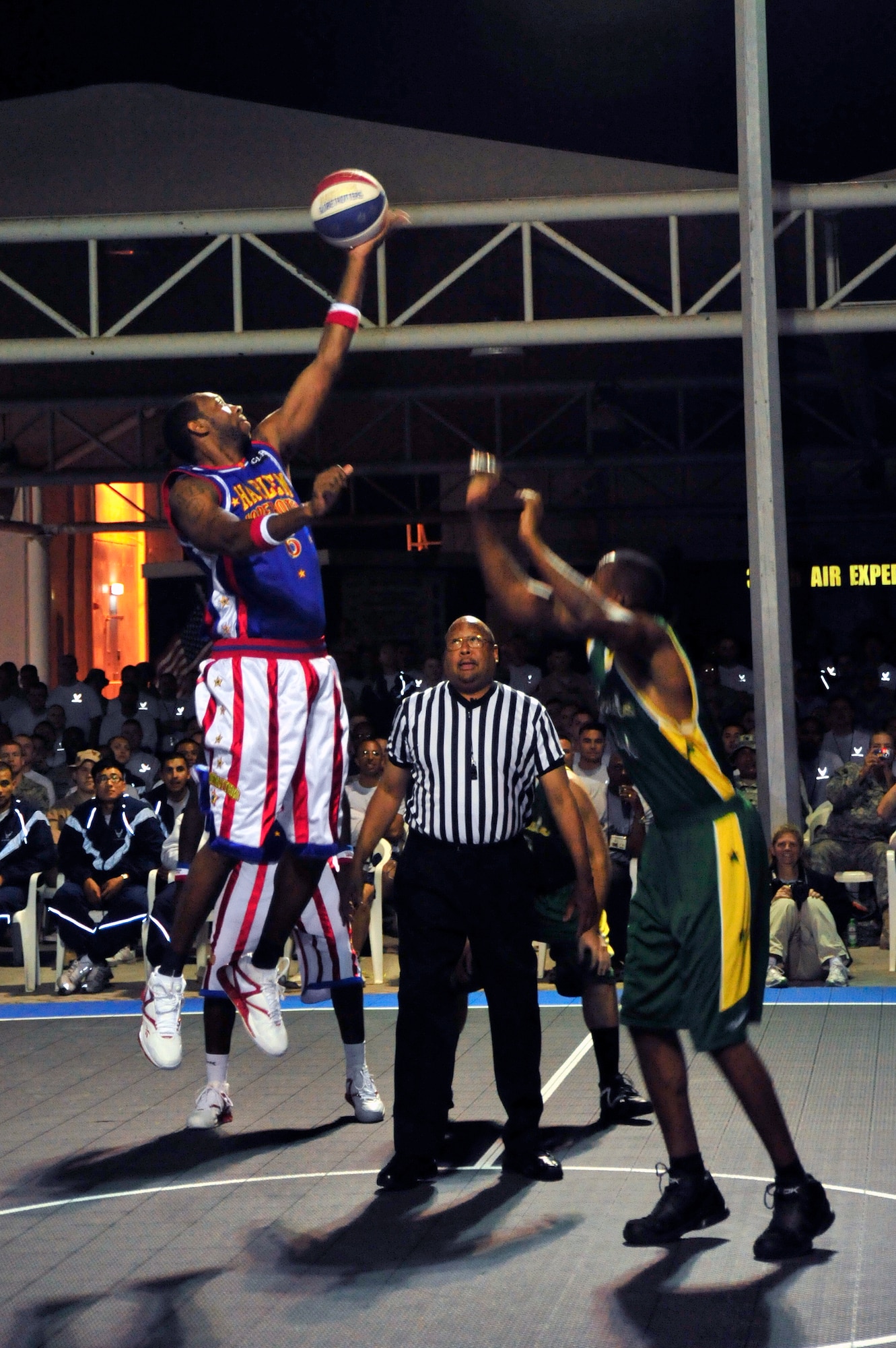 SOUTHWEST ASIA - "Airport" Greenup from the Harlem Globetrotters wins the tip off at the start of the game, played against the Washington Generals Dec. 4, 2009 at the 380th Air Expeditionary Wing. The Globetrotters performed courtesy of the Armed Forces Entertainment while touring 10 countries in Southwest Asia. (U.S. Air Force photo/Tech. Sgt. Charles Larkin Sr)