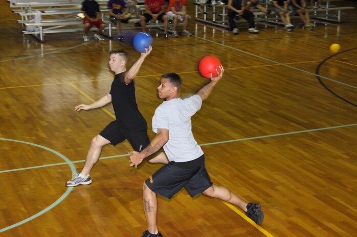 Tony Orth (left) and Jacob Moore (right) utilize their team strategy of the double team during the 8th Annual Dodge Ball Tournament held at IronWorks Gym here Saturday.