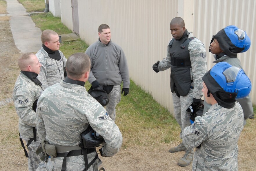 KUNSAN AIR BASE, Republic of Korea -- Instructor Staff Sgt. Jose Tomlinson, 8th Security Forces Squadron, briefs the team about the results of the scenario during simulated rounds training here Dec. 2. The Simulated rounds training taught new Security Forces members proper ways to clear a building by engaging them with various situations. After each scenario the instructors correct mistakes, demonstrate the proper techniques, and highlight good methods applied. (U.S. Air Force photo/Staff Sgt. Darnell T. Cannady)
