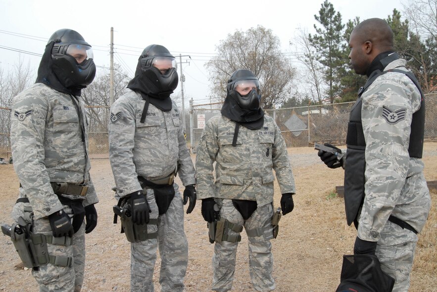 KUNSAN AIR BASE, Republic of Korea -- Instructor Staff Sgt. Jose Tomlinson, 8th Security Forces Squadron, briefs the team of Airman 1st Class Samuel Rios, Staff Sgt. Robert Sappington, and Senior Airman Robert Davis, all work for the 8th Security Forces Squadron, during simulated rounds training here Dec. 2. The Simulated rounds training taught new Security Forces members proper ways to clear a building by engaging them with various situations. Prior to each situation the team receives a briefing about the scenario prior to entrance inside the building. (U.S. Air Force photo/Staff Sgt. Darnell T. Cannady)