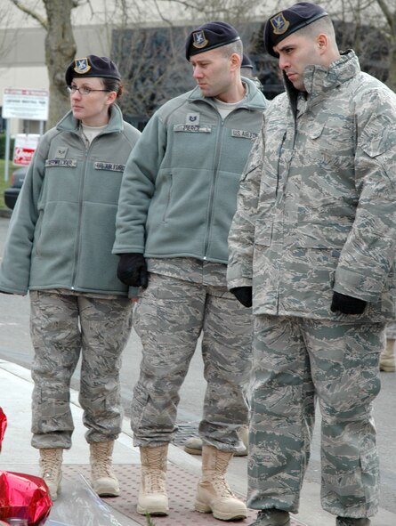 LAKEWOOD, Wash. - (left to right) Senior Airman Melissa Terwilliger, Tech. Sgt. Christopher Pierce and Staff Sgt. Alfredo Garza, reservists with the 446th Security Forces Squadron, McChord Air Force Base, Wash., pay their respects during their visit to the memorial site located at the Lakewood Police Department, Dec. 6.  The Reservists had a moment of silence to honor their fellow police officers who were killed on Nov. 29. (U.S. Air Force photo/Staff Sgt. Nicole Celestine)