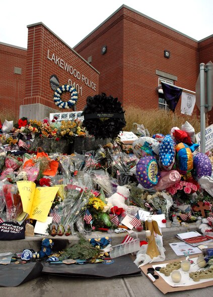 LAKEWOOD, Wash. - A memorial is in full bloom outside the Lakewood Police Department, in memory of the four police officers who were killed in an apparent ambush in a coffee shop in the area on Nov. 29.  Air Force Reservists with the 446th Security Forces Squadron, McChord Air Force Base, Wash., visited the memorial site on Dec. 6, to pay their respects and offer their condolences. (U.S. Air Force photo/Staff Sgt. Nicole Celestine).