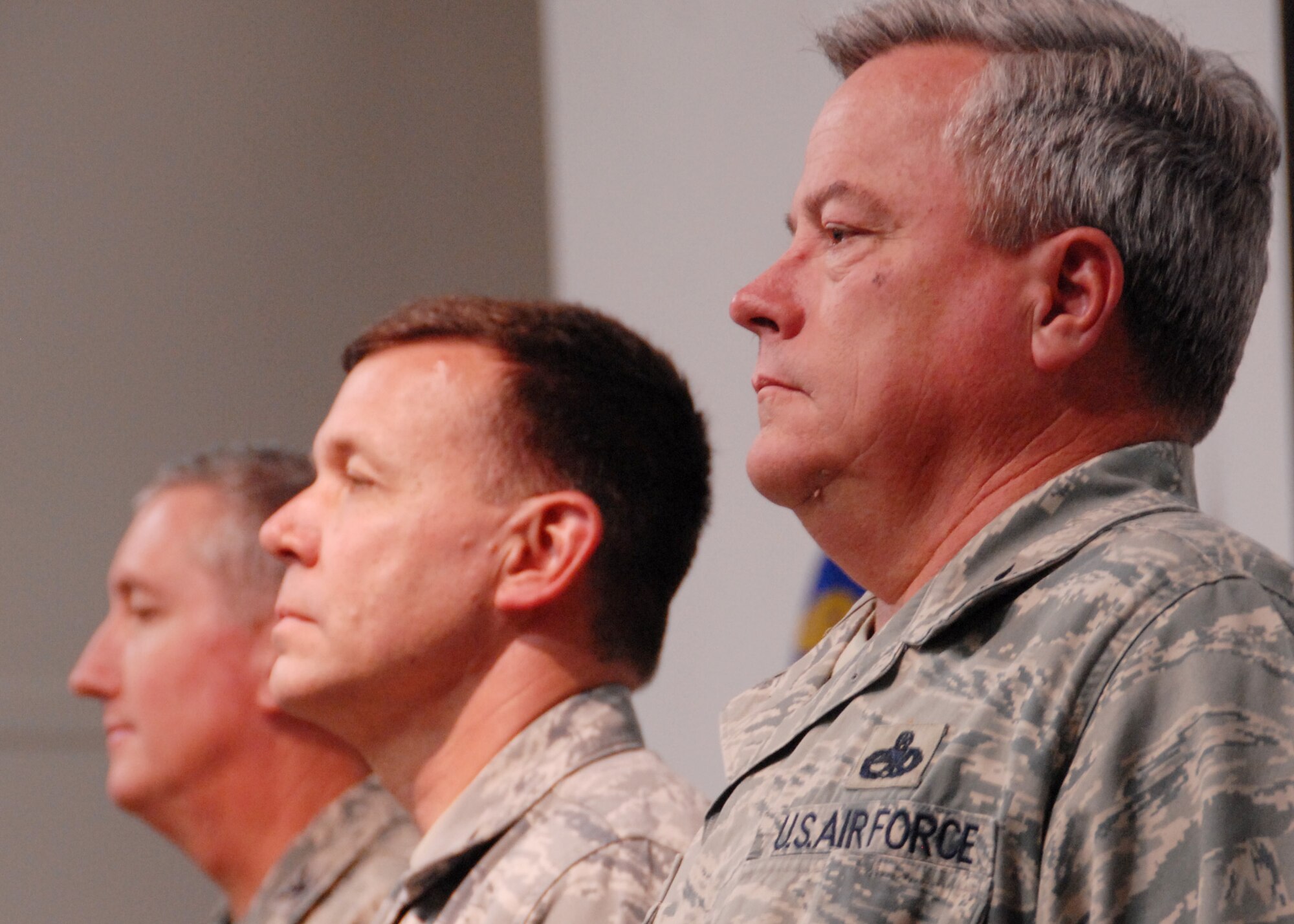 (Right to left) Col. Kenneth Honaker, Col. James Brock, and Col. Jon Weeks, 919th Special Operations Wing commander stand at attention during the National Anthem at the 919th Maintenance Group change of command ceremony Dec. 5.  Colonel Honaker assumed command from Colonel Brock.  (Air Force photo/Staff Sgt. Samuel King Jr.)