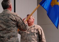 Col. Kenneth Honaker, salutes Col. Jon Weeks, 919th Special Operations Wing commander, before accepting the guidon of the 919th Maintenance Group during the change of command ceremony Dec. 5 at Duke Field.  He took command from Col. James Brock.  (Air Force photo/Staff Sgt. Samuel King Jr.)