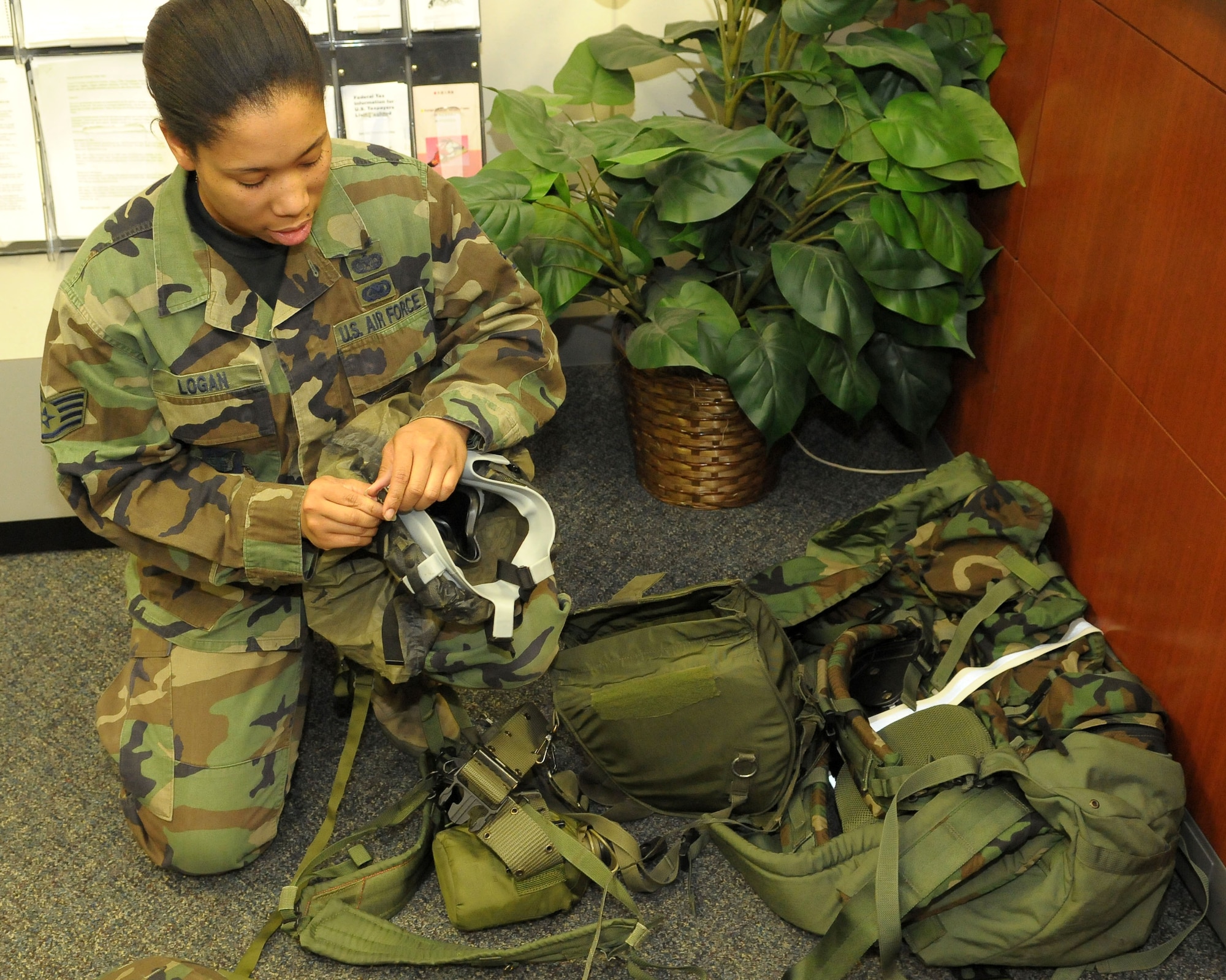 YOKOTA AIR BASE, Japan -- Staff Sgt. Veronica Logan, 374th Airlift Wing Staff Judge Advocate, inspects her individual protective equipment Dec. 6 prior to an operational readiness inspection conducted by the Pacific Air Forces Inspector General. (U.S. Air Force photo/Airman 1st Class Sean Martin)