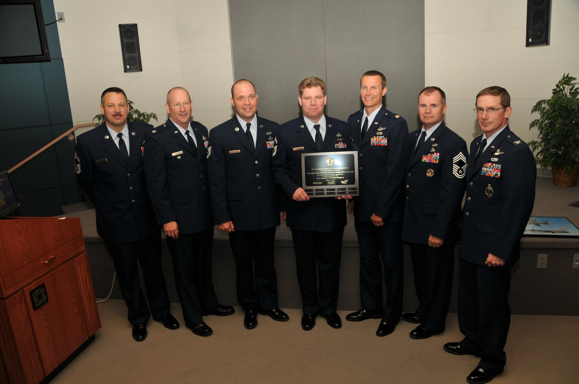 The 115th Fighter Wing in Madison, WI, received the highest safety award, known as the Volunteer Protection Program star rating, by the Occupational Safety and Health Administration.  From the left are Chief Master Sgt. Mark Petty, 115th FW safety, Lt. Col. Doug Slocum, ANG director of safety, Tech. Sgt. Jason Kasten, the 115th FW grounds safety technician, Senior Master Sgt. Tom Egstad, NCOIC of ground and weapons safety, Maj. Chad Milne, 115th FW safety, Chief Master Sgt. Monte Page, NGB occupational safety division, and Col. Joseph Brandemuehl, the 115th FW commander.  The 115th FW is only the second Air National Guard unit and the third Air Force base in the country to receive a star rating in the VPP process.  (U.S. Air Force photo by Airman 1st Class Ryan Roth)