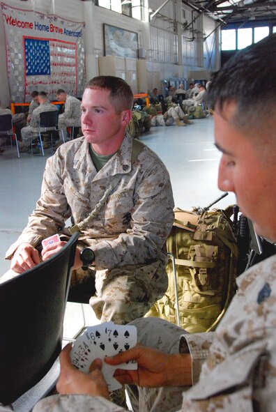 A group of Marines from Camp Pendleton’s I Marine Expeditionary Force play cards supplied by hangar staff as they wait for their flight Nov. 17. (U.S. Air Force photo by Megan Just)