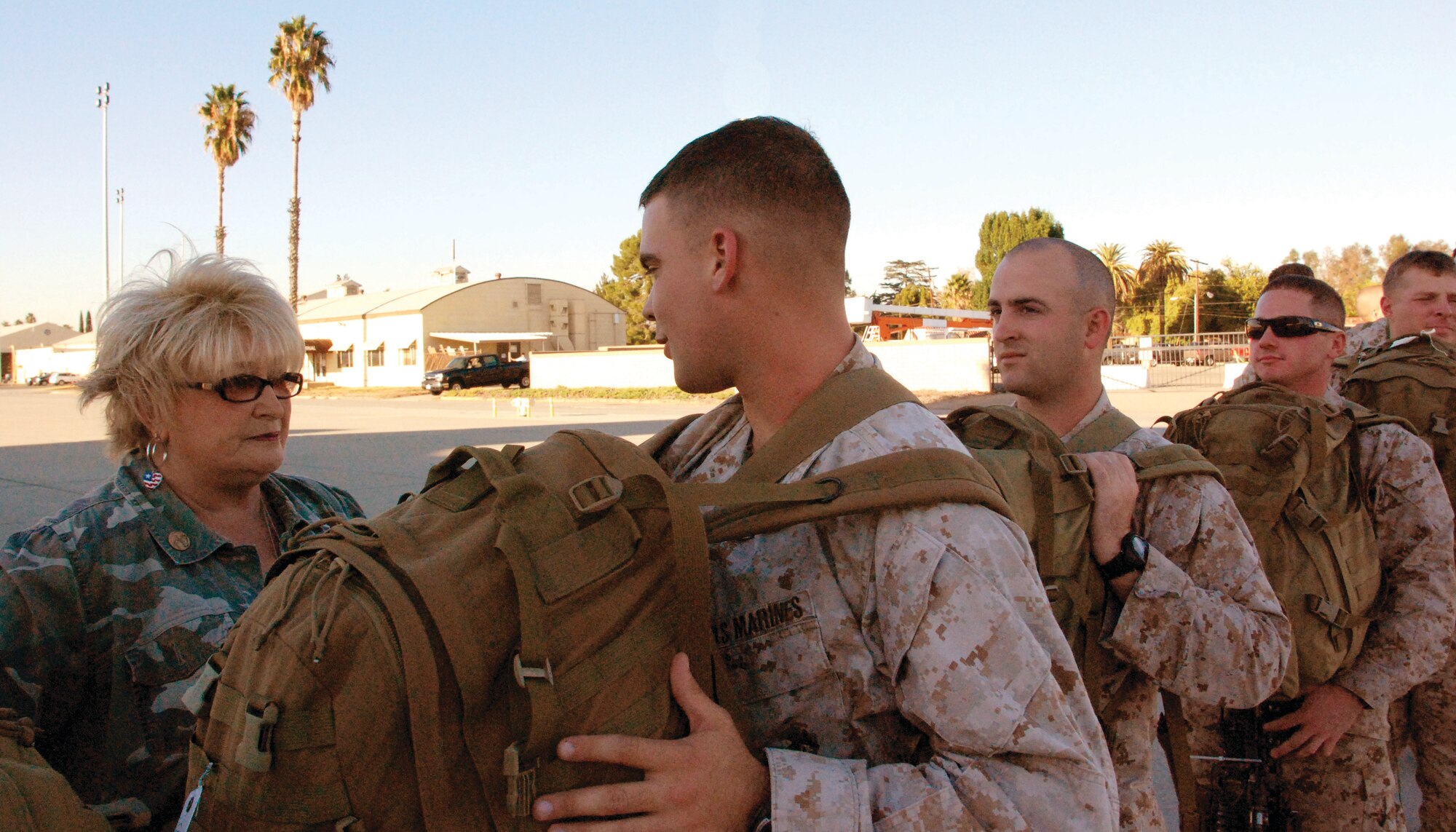 Mrs. Laura Froehlich says good-bye to each of the 108 Marines who deployed from March ARB’s deployment hangar Nov. 17.  The Marines were from the 1st Marine Expeditionary Force at Camp Pendleton. (U.S. Air Force photo by Megan Just)
