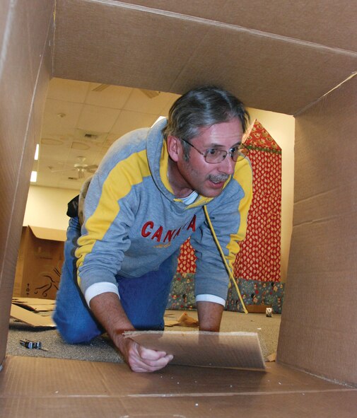 Mike Kastner crawls into a tunnel to add reinforcement for stability.  (U.S. Air Force photo by Staff Sgt. Megan Crusher)