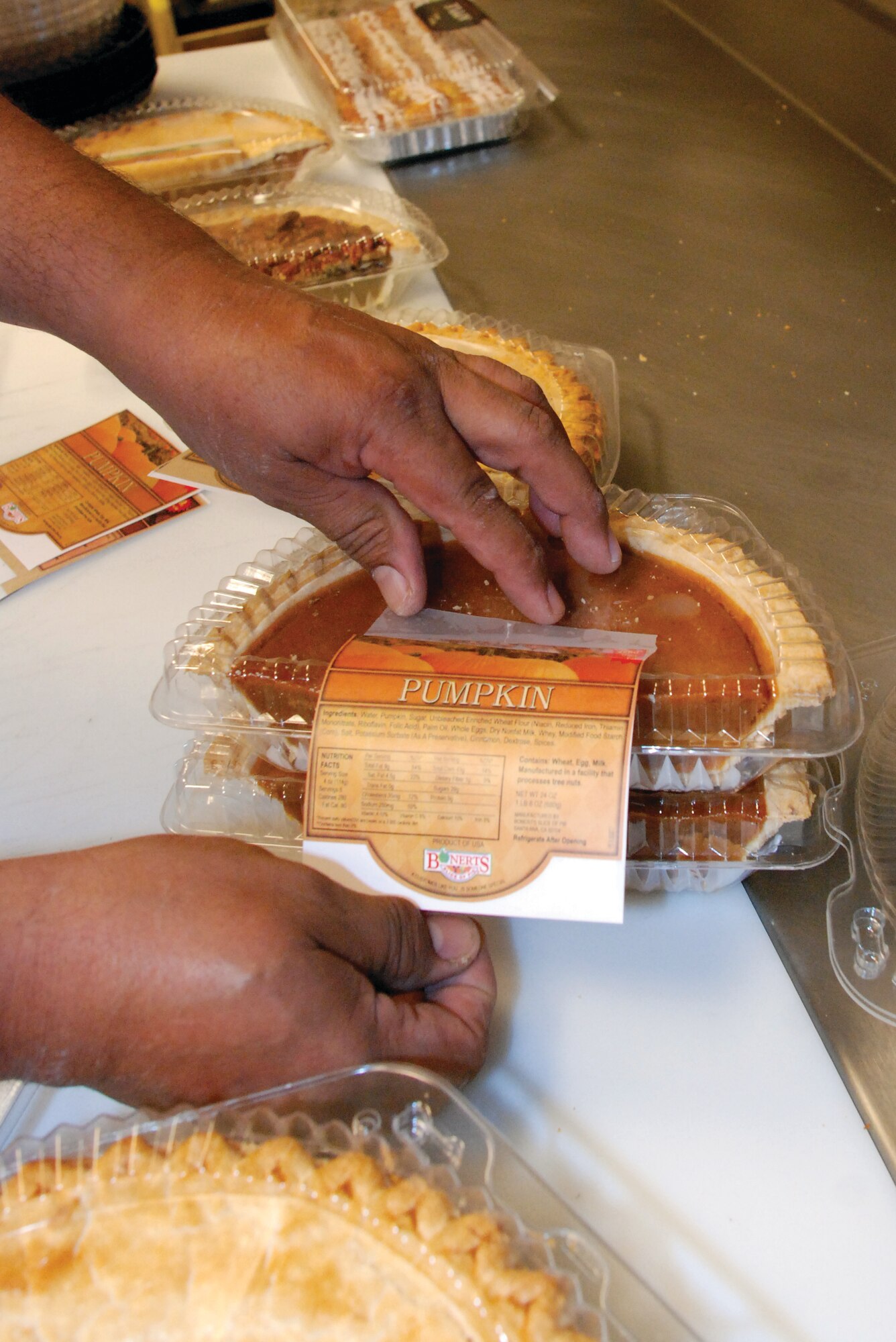 Juan Aleman,  deli and bakery manager, packages and labels pie halves in the bakery at the March ARB Commissary Nov. 13.  Aleman said the most popular types of pies at March for Thanksgiving are sweet potato, pumpkin and apple.  The Commissary also serves strawberry, apple and cherry pies.   (U.S. Air Force photo by Megan Just)