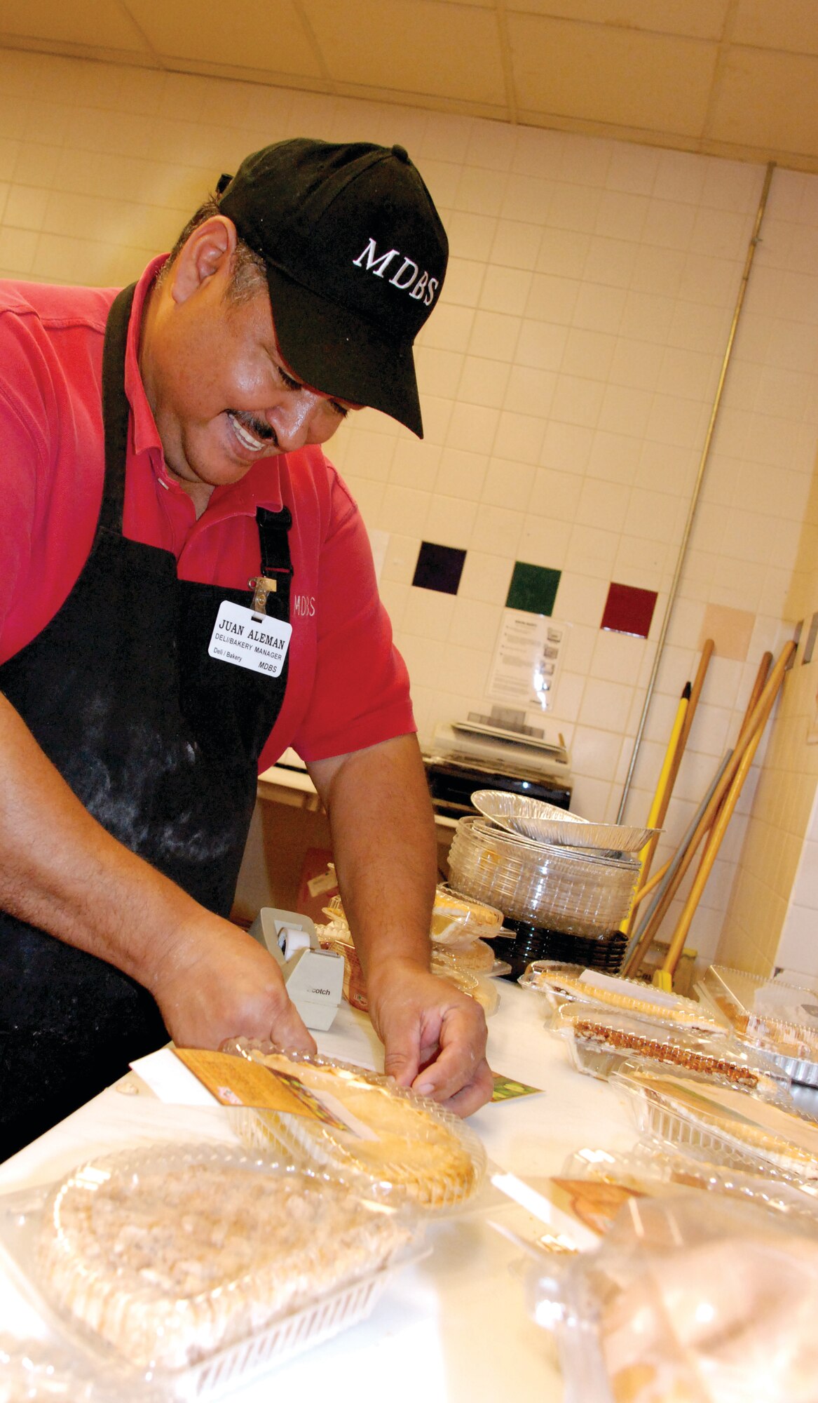 Juan Aleman,  deli and bakery manager, packages and labels pie halves in the bakery at the March ARB Commissary Nov. 13.  Aleman said the most popular types of pies at March for Thanksgiving are sweet potato, pumpkin and apple.  The Commissary also serves strawberry, apple and cherry pies.   (U.S. Air Force photo by Megan Just)