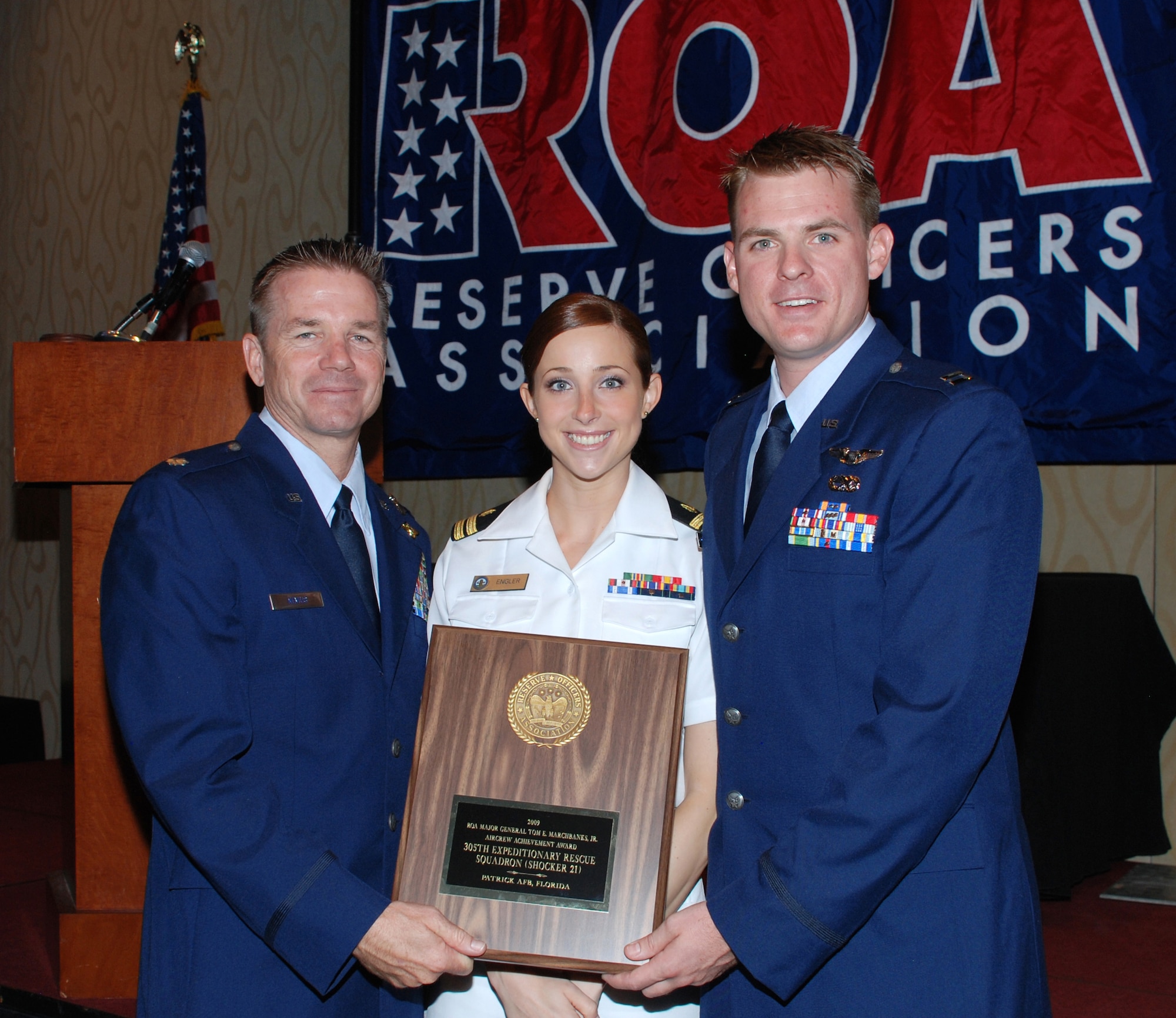 Helicopter pilot Lt. Col. Paul Nevius, critical care nurse Navy Lt. j.g. Rachel Engler and co-pilot Capt. Brough McDonald took part in the battlefield medical evacuation mission that garnered the Thomas E. Marchbanks award for valor at this year's Reserve Officers Association convention. While evacuating several injured Soldiers and rearming special forces troops on the ground, the HH-60 helicopter crew was drawn into the fight. The crew maneuvered their aircraft to protect the special operations team, eliminated eight Taliban fighters including three high-value targets, and forced the retreat of over 30 insurgents. (U.S. Air Force photo by Tech. Sgt. Heather Kelly) 