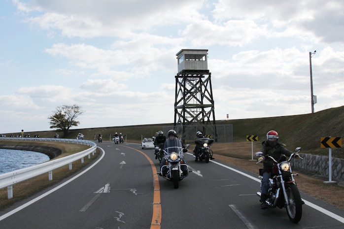 More than 130 motorcycles cruise around Penny Lake during the Toys for Tots Motorcycle Rally here Dec. 6.::r::::n::The annual event promotes the Corps’ Toys for Tots campaign, which collects new, unwrapped toys each year::r::::n::and distributes the gifts to needy children in the community where the campaign was conducted.